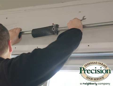 Technician Repairing Garage Door